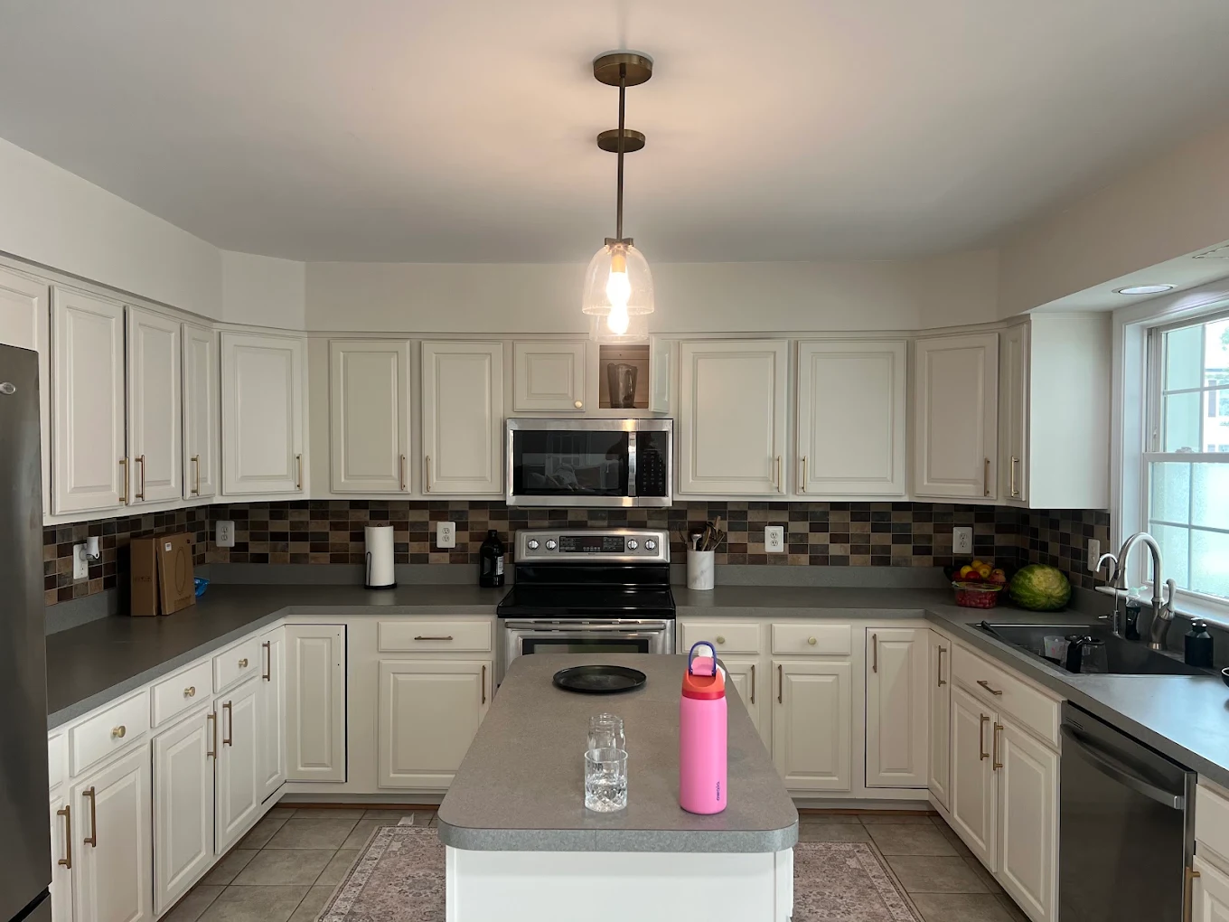 Kitchen with freshly painted white cabinetry